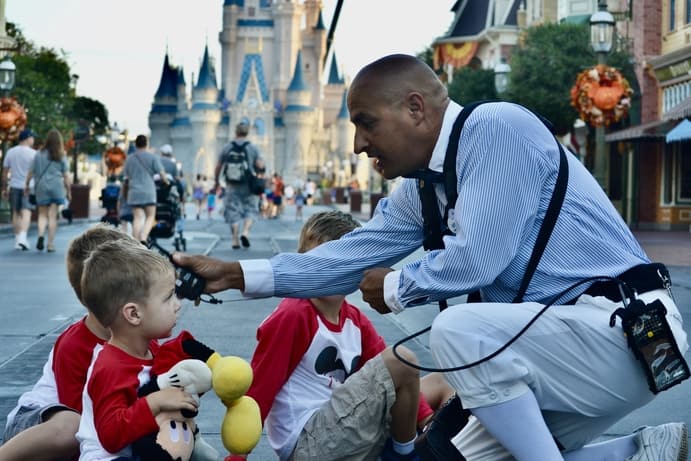 Disney photo pass photographer taking picture in front of castle in magic kingdom