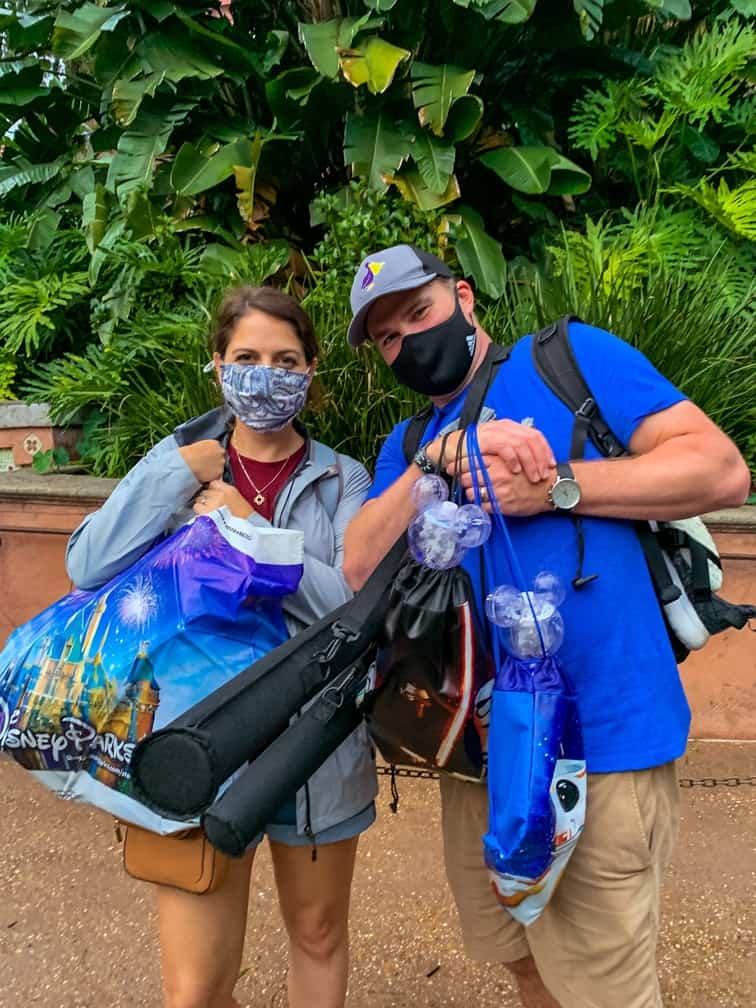 Parents carrying droid and lightsabers in hollywood studios